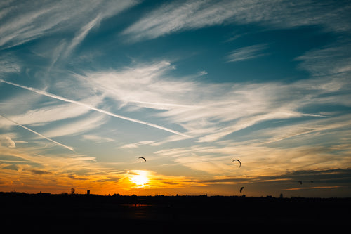 kite flying during sunset
