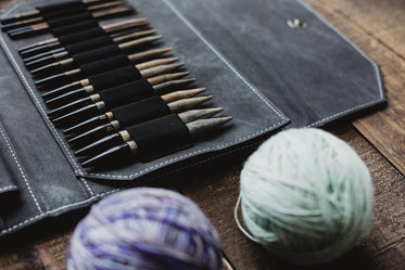 knitting needles and yarn on a wooden table