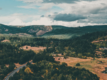 landscape of tree covered hills and brown valleys