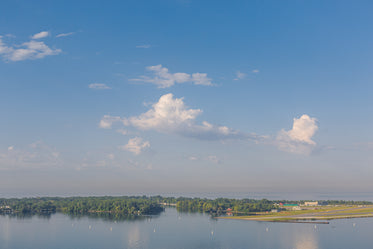 large cloudy sky overlooking water and islands