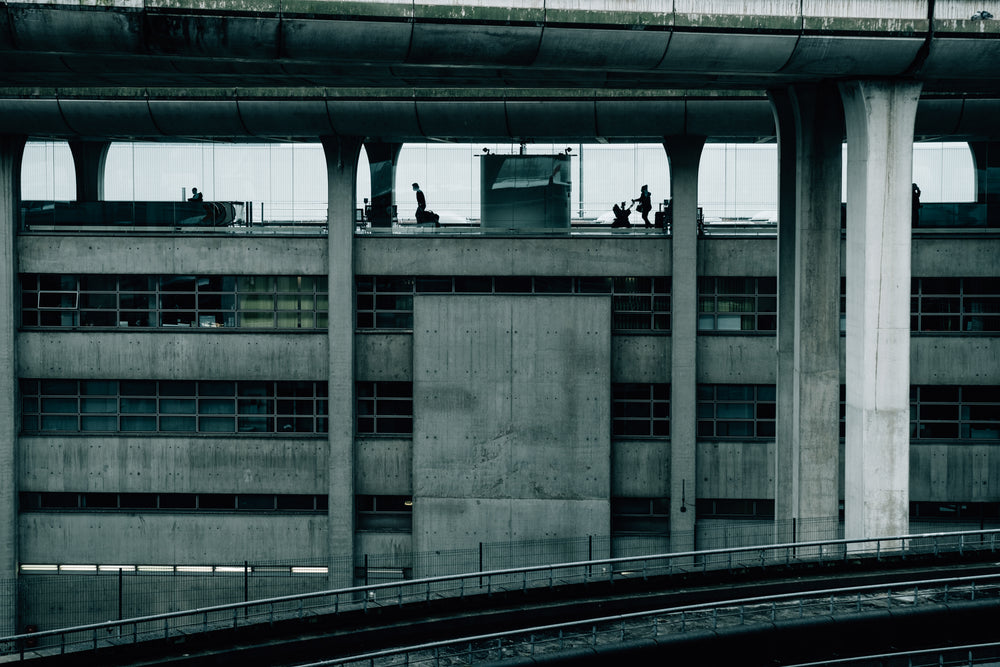 large concrete building with people working at desks inside