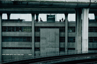 large concrete building with people working at desks inside