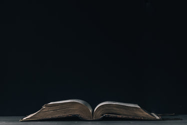 large leatherbound book on a bare table