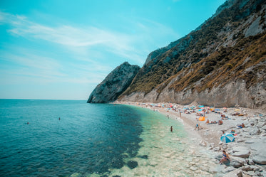 large mountains with a small busy beach