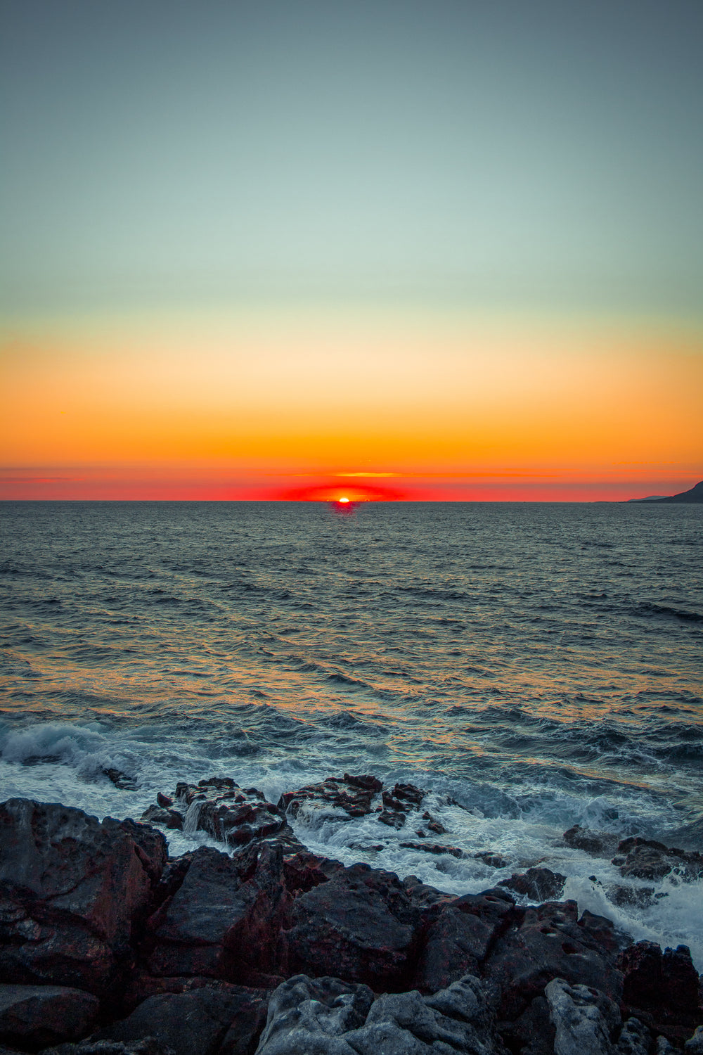 last moments of a sunset over the rocky shore