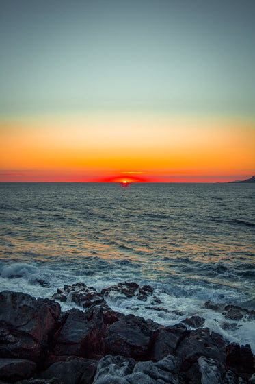 last moments of a sunset over the rocky shore