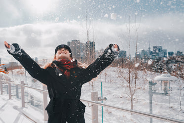 laughing woman in snowy urban park