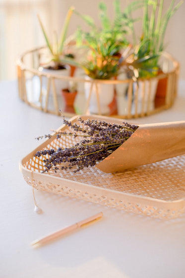 lavender bundle in a white wicker tray