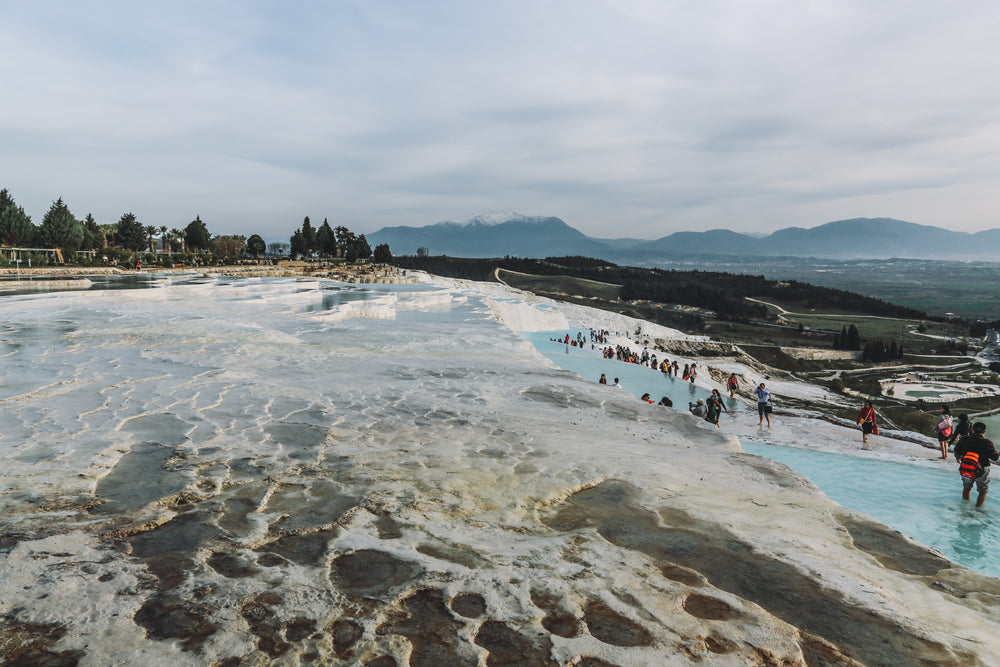 layered thermal pools with tourists