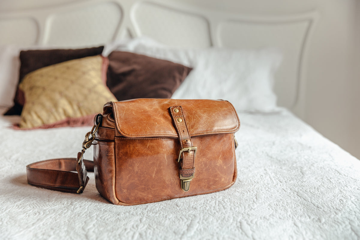 leather handbag on bed