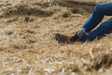 legs crossed & relaxing in hay