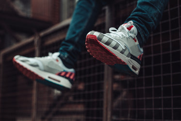 legs dangling over ledge showing off fashion sneakers