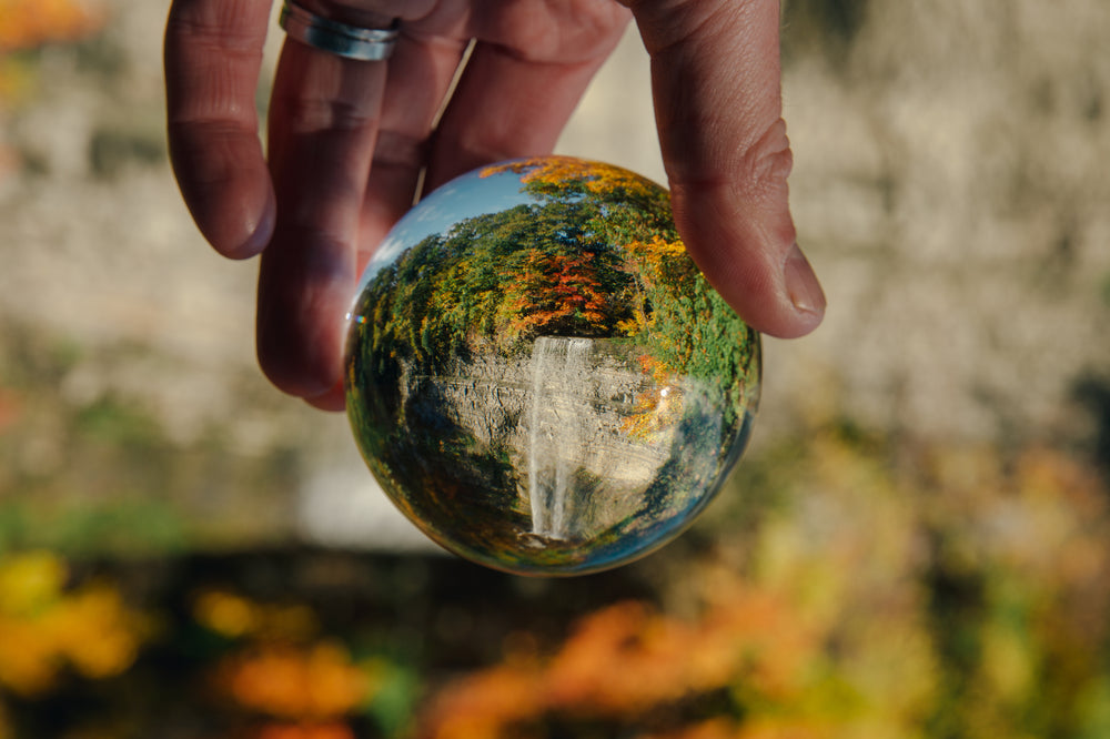 lens ball with fall trees and waterfall