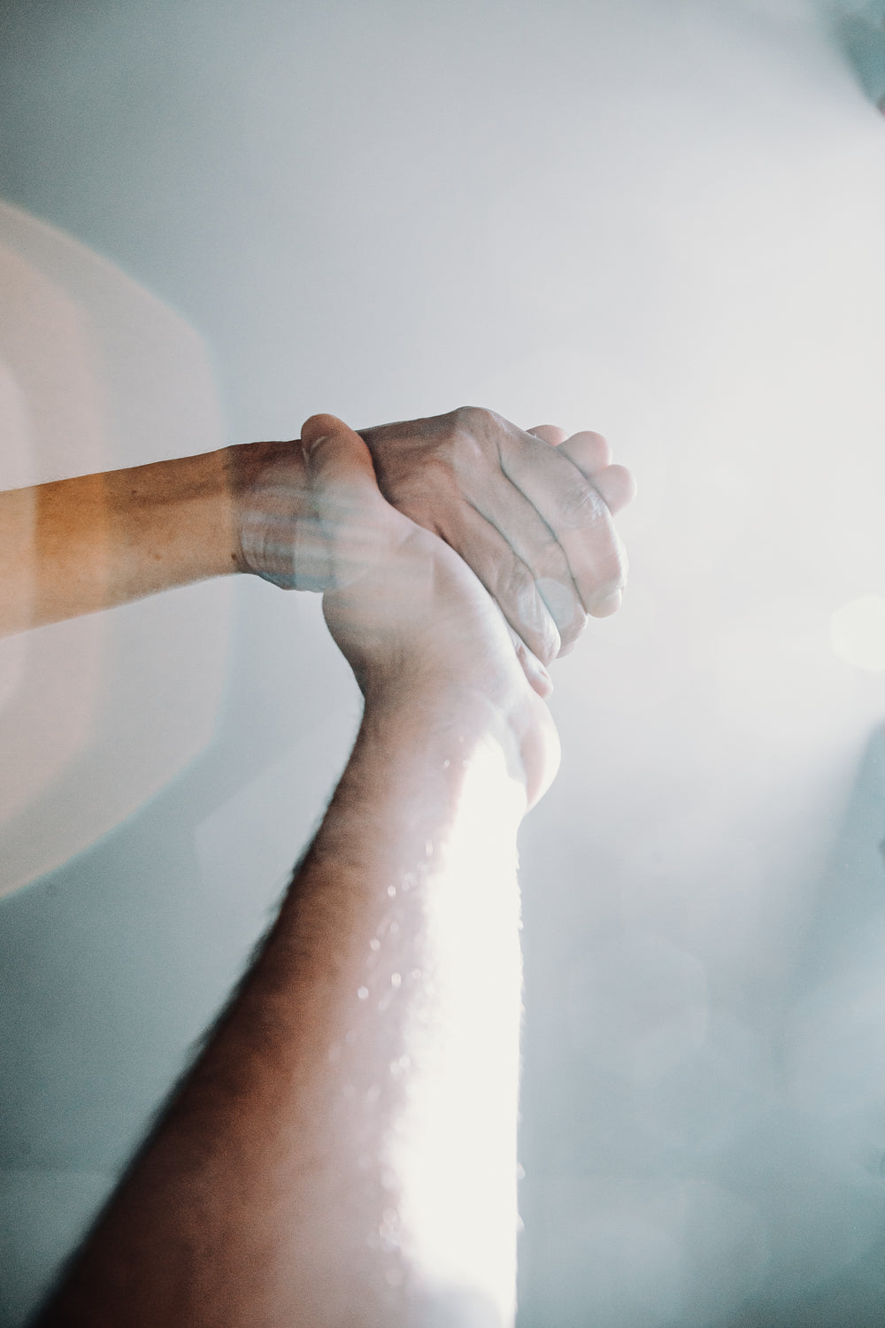 lens flare across holding hands