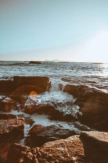 lens flare on shoreline rocks