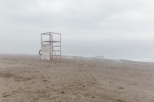 lifeguard stand on grey beach