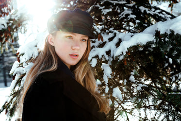 light flare behind woman in snowy wood