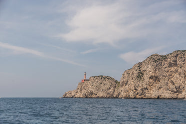 light house on rocky cliff in italy