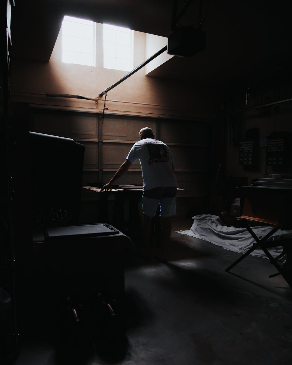 light pours in illuminating a person leaning over a table