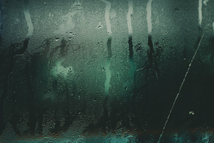 City light refracted through a rain covered window at night