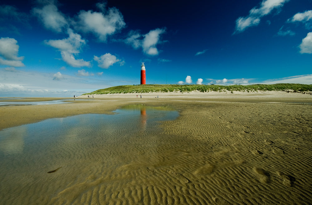 lighthouse blue sky and beach pools