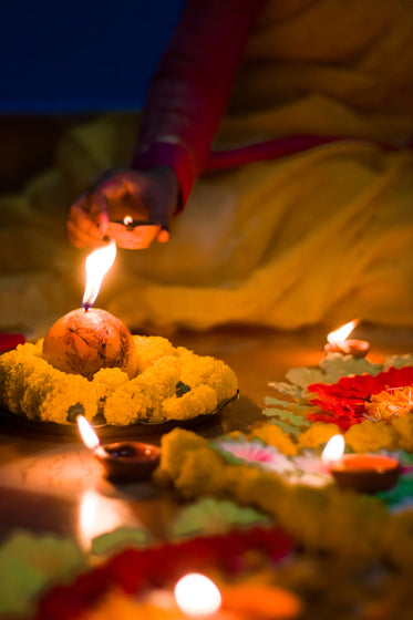lighting colorful candles for diwali