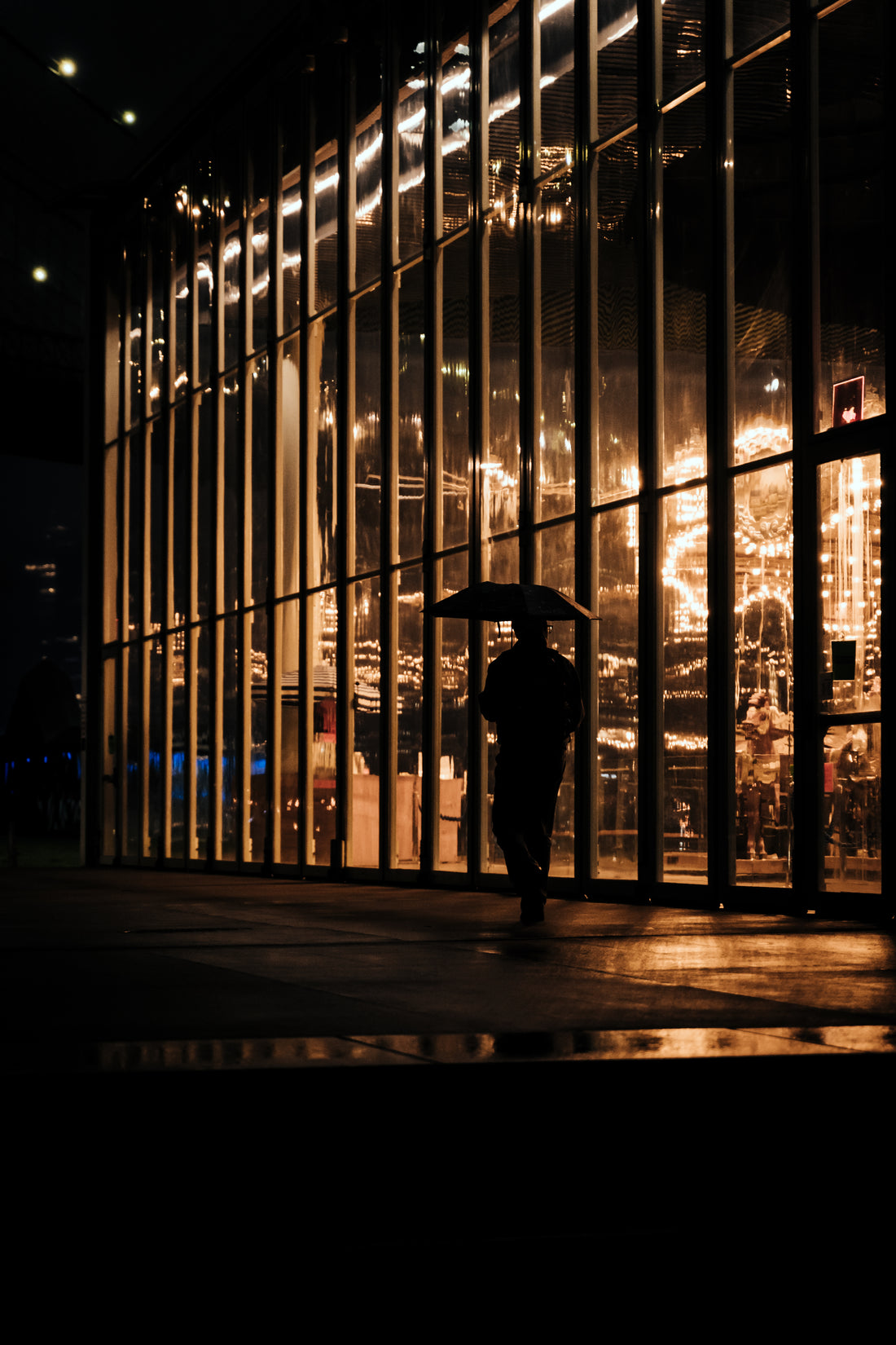 City lights blurred through falling rain
