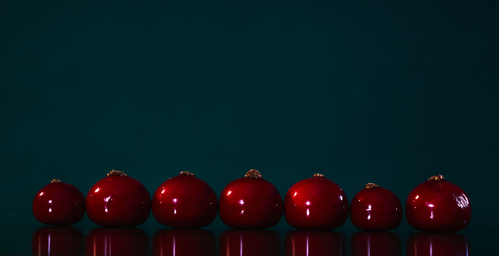 line of rich red berries on blue background
