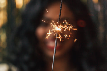 lit sparkler and smile