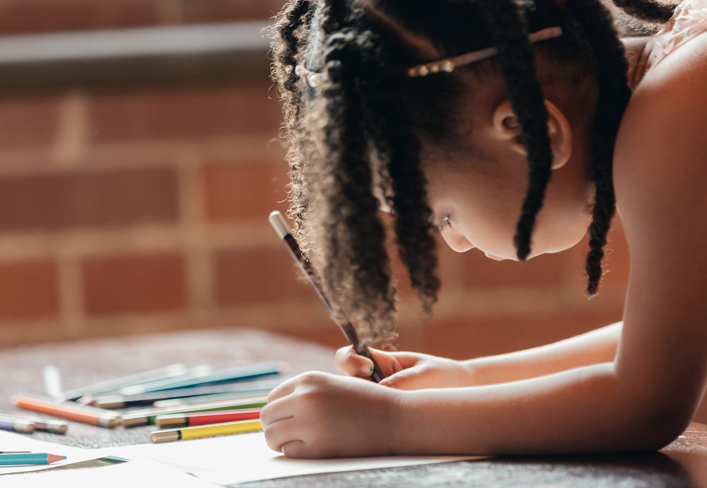 little girl drawing is focused