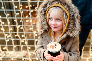 little girl with hot chocolate