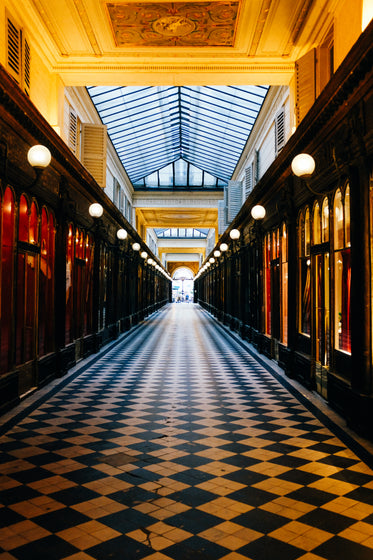 long hallway in yellow and black with checkered floors