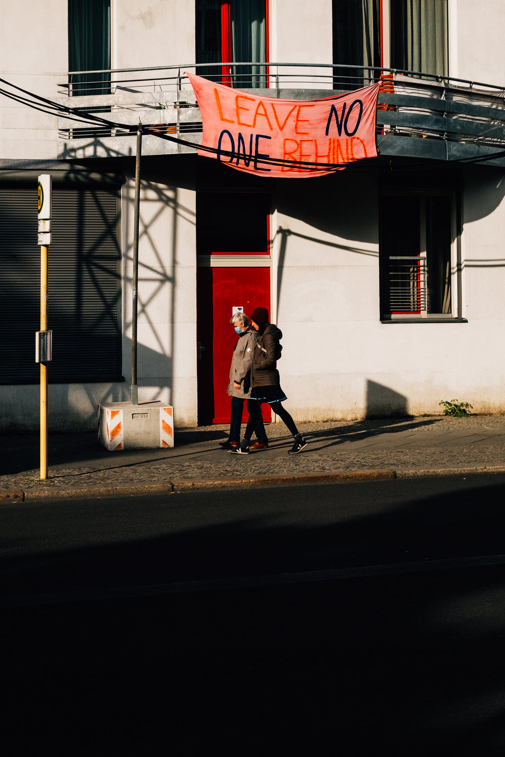 long shadows of people walking by