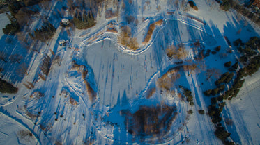 long winter shadows aerial of skating pond
