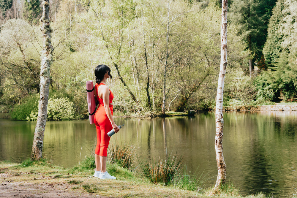 looking out at a pond while wearing athletic wear