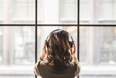 looking out window wearing headphones