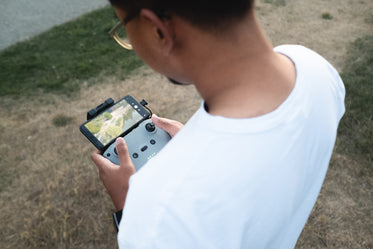 looking over the shoulder of someone holding a drone