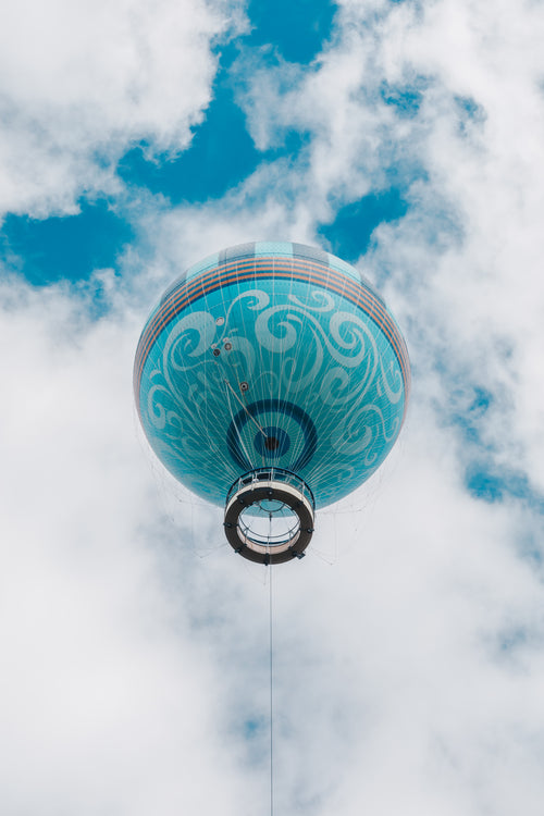 looking skyward to a whimsical blue hot air balloon