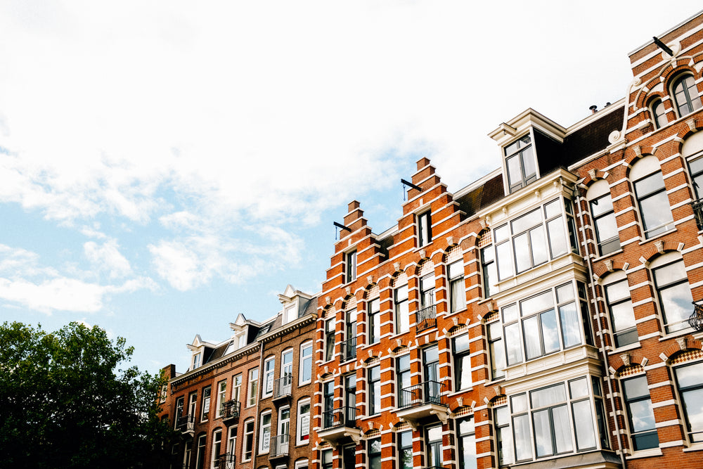 looking up at line of brick buildings