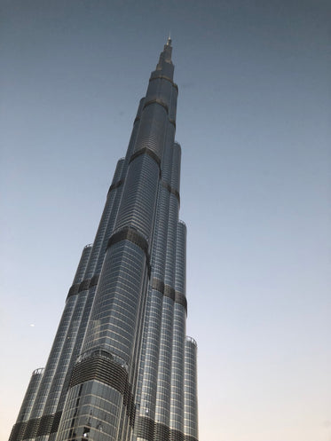 looking up at tall building against a clear blue sky