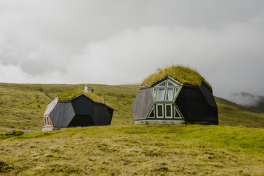 looking up the hill towards two geodesic homes in the fog