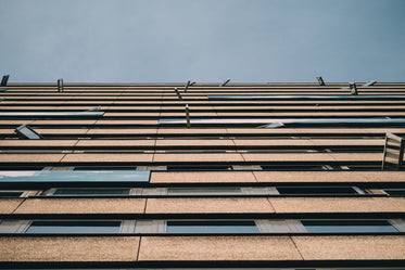 looking up towards the sky at a grey building