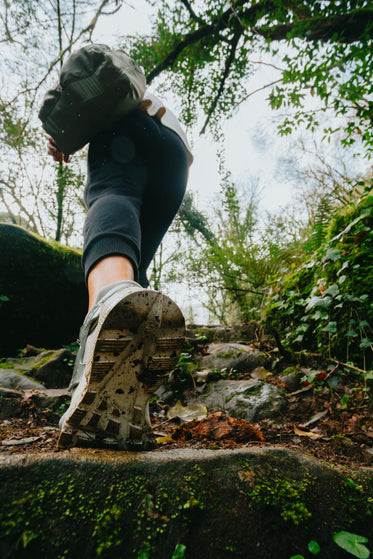 low angle view of a person hiking up a stone pathway