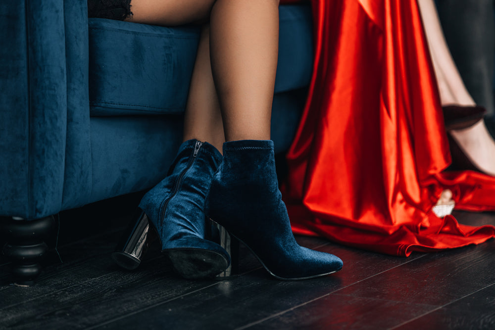 low shot of women sitting on velvet couch