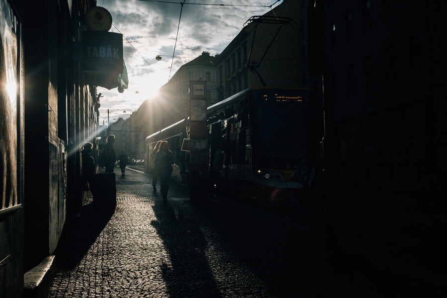 Low sun silhouetting people on a city street