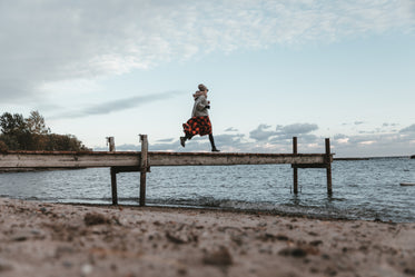 low view of a young woman running across dock