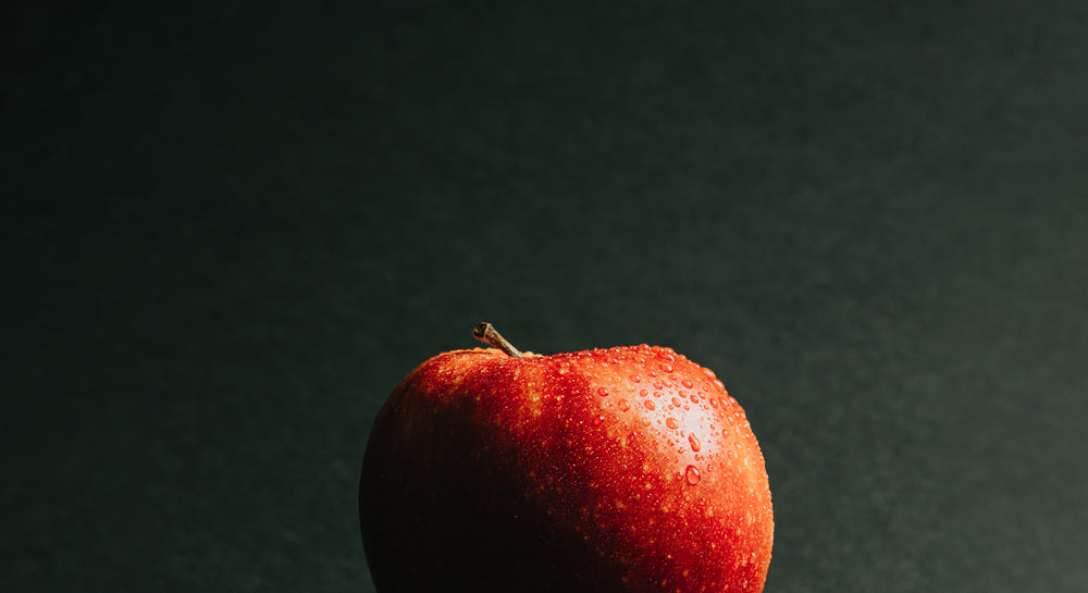 macro water drops on a red apple