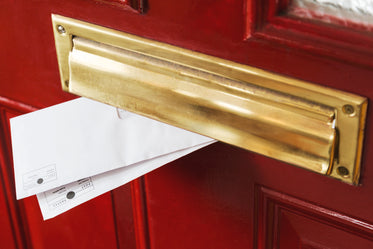 mail peeks out from a brass letterbox