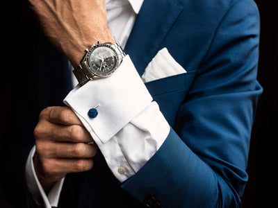 Man Adjusts His Shirt Cuffs Below Watch