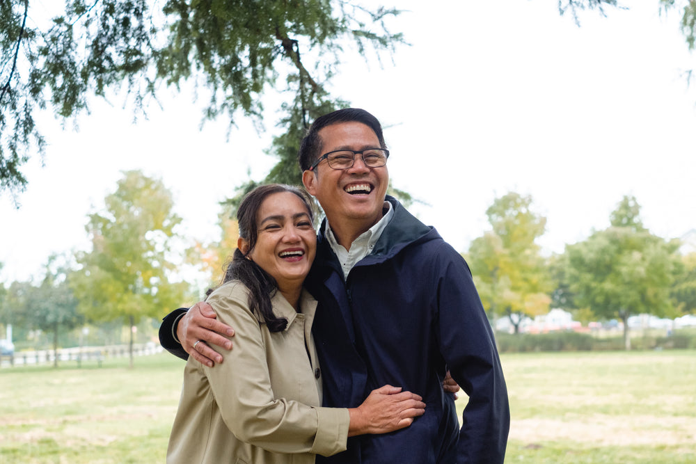 man and woman hug and laugh